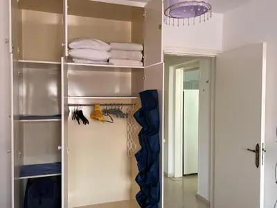 a walk in closet with towels on shelves at TaniAndres apartments in Paralimni