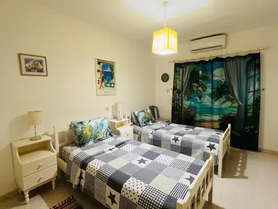 a bedroom with two beds and a window at TaniAndres apartments in Paralimni