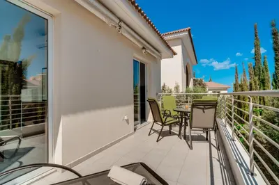 a patio with a table and chairs on a balcony at Lovely 2 Bedroom Family Apartment w/ Pool in Protaras