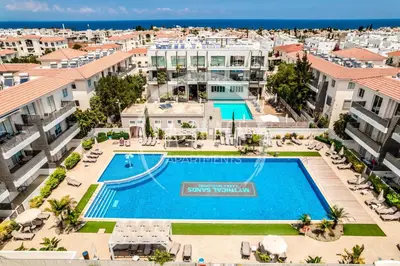an aerial view of a resort with a swimming pool at Lovely 2 Bedroom Family Apartment w/ Pool in Protaras