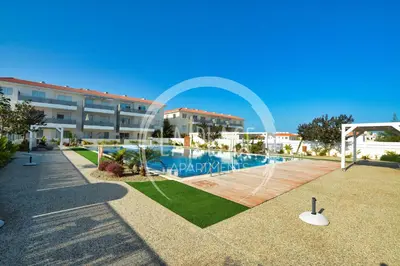 a swimming pool in front of a building at Lovely 2 Bedroom Family Apartment w/ Pool in Protaras