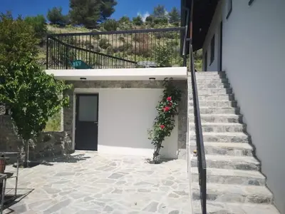 a garage with a white door and stairs at Veranda in Agros
