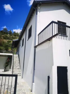 a white building with a staircase and a balcony at Veranda in Agros