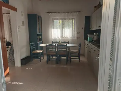 a kitchen and dining room with a table and chairs at Veranda in Agros
