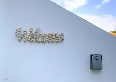 a bunch of pills spelling out the word help on a white wall at The MedView Garden House in Pervolia