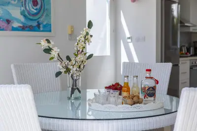 a glass table with bottles and drinks on it at Oceania Villa in Protaras