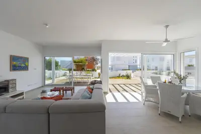 a living room with a couch and a table at Oceania Villa in Protaras