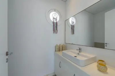 a bathroom with a sink and a mirror at Oceania Villa in Protaras