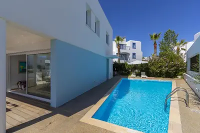 a swimming pool in the backyard of a house at Oceania Villa in Protaras