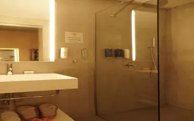 a bathroom with a glass shower and a sink at Madama Residence in Nicosia