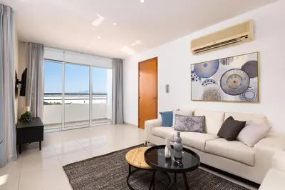 a living room with a couch and a table at The Saline Views Makenzy in Larnaka