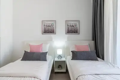 two beds sitting next to each other in a bedroom at Aziza 1- Bedroom Apartment in Larnaca in Larnaka