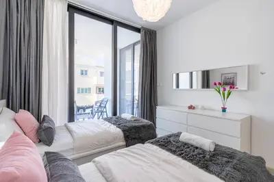 a bedroom with two beds and a large window at Aziza 1- Bedroom Apartment in Larnaca in Larnaka