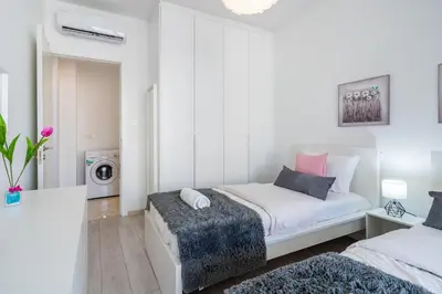a bedroom with a bed and a washing machine at Aziza 1- Bedroom Apartment in Larnaca in Larnaka