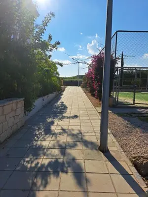 a sidewalk with a light pole on it at Carme at the Beach - Mythical Sands in Paralimni