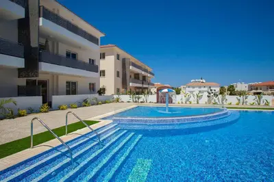 a swimming pool in front of a building at Carme at the Beach - Mythical Sands in Paralimni