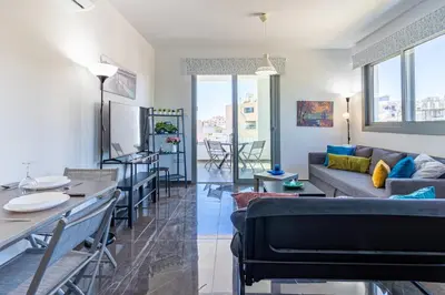 a living room with a couch and a table at Kmeidos 1-Bedroom Apartment in Larnaca in Larnaka