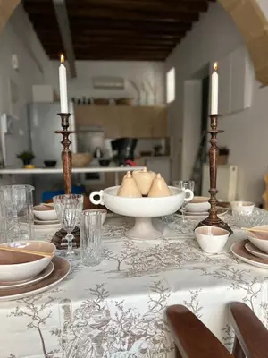 a table with a white table cloth with candles on it at The Old Town Heritage House in Nicosia