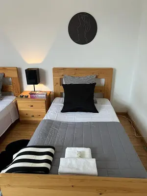 a bedroom with a large bed with black and white pillows at APHRODITE 2 Bedroom Apartment Down Town Nicosia in Nicosia