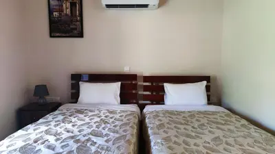 two beds sitting next to each other in a bedroom at Limeria in Alona