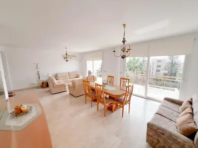 a living room with a table and chairs and a couch at Samson Sea Breeze, 3bed sleeps 6, free WiFi in Limassol