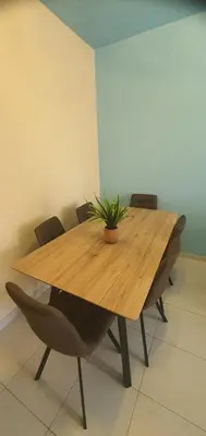 a wooden table with chairs and a potted plant on it at STEFARIS 
