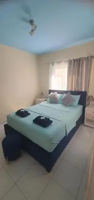 a bedroom with a large bed with two towels on it at STEFARIS 