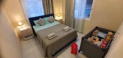 a small bedroom with a bed and a suitcase at STEFARIS 