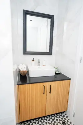 a bathroom with a sink and a mirror at Palazzino Luxury Suites in Lofou