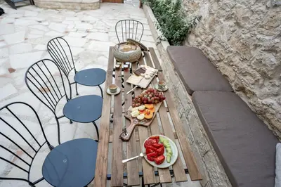 a picnic table with a plate of fruit on it at Palazzino Luxury Suites in Lofou