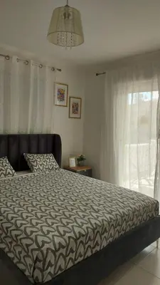a bedroom with a large bed and a window at Nissi Golden Sands Sunny Apartment A1D4 in Ayia Napa