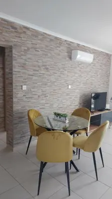 a dining room with a glass table and chairs at Nissi Golden Sands Sunny Apartment A1D4 in Ayia Napa