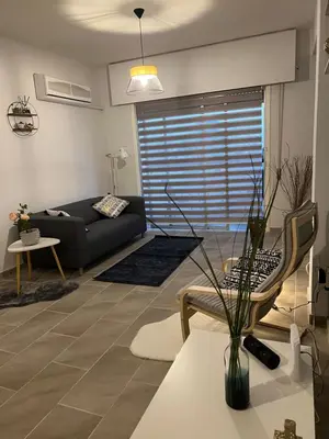 a living room with a couch and a table at Joanna Court rooms in Larnaka