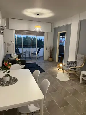 a living room with a white table and chairs at Joanna Court rooms in Larnaka