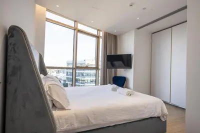 a bedroom with a large bed and a large window at 360 Nicosia - 1 bedroom Luxurious Residence in Nicosia
