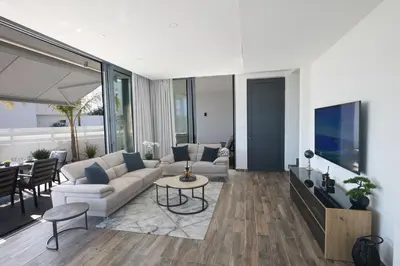 a living room with a couch and a table at Almaria Villas in Protaras