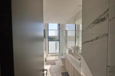 a bathroom with a tub and a toilet and a window at Almaria Villas in Protaras