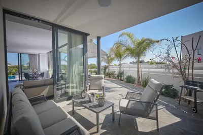 a living room with a couch and chairs on a patio at Almaria Villas in Protaras