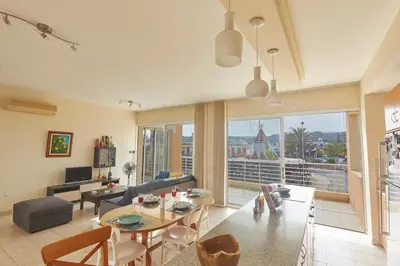 a living room with a couch and a table at Spectacular Sea View, private jacuzzi & table pool in Protaras
