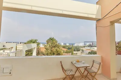 a balcony with a table and chairs and a view at Spectacular Sea View, private jacuzzi & table pool in Protaras