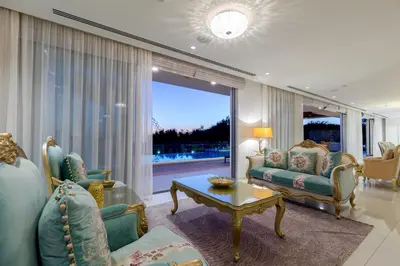 a living room with a couch and a table at Palace of Mediterranean Beachfront Villa in Ayia Napa