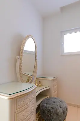a dressing room with a mirror and a dressing table at Palace of Mediterranean Beachfront Villa in Ayia Napa