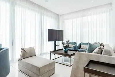 a living room with a couch and a tv at Del Mar Beachfront 3 Bedroom 'C' Residence in Limassol