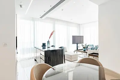 a white living room with a table and chairs at Del Mar Beachfront 3 Bedroom 'C' Residence in Limassol