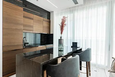 a kitchen with a glass table and two chairs at Del Mar Beachfront 3 Bedroom 'C' Residence in Limassol