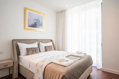a bedroom with a bed with two towels on it at Del Mar Beachfront 3 Bedroom 'C' Residence in Limassol