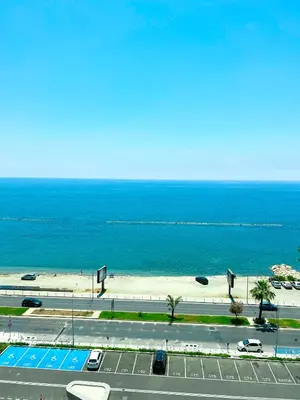 a view of a road and a beach with the ocean at Del Mar Beachfront 3 Bedroom 'C' Residence in Limassol