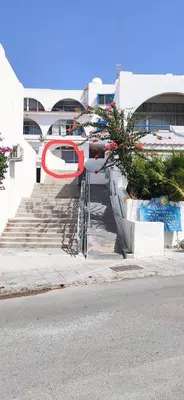 a stairway leading to a building with a sign on it at Pissouri bay studio in Pissouri