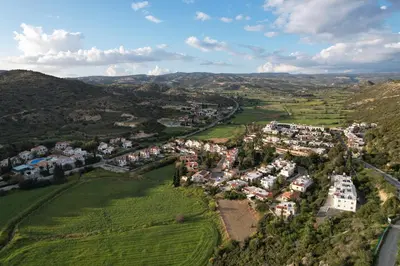 an aerial view of a village in the hills at Pissouri bay studio in Pissouri