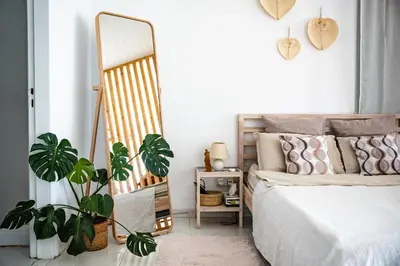 a bedroom with a bed and a mirror at Pissouri bay studio in Pissouri